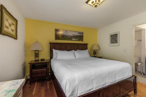 a bedroom with a large bed and two night stands at Woodbridge Condo by Snowmass Vacations in Snowmass Village