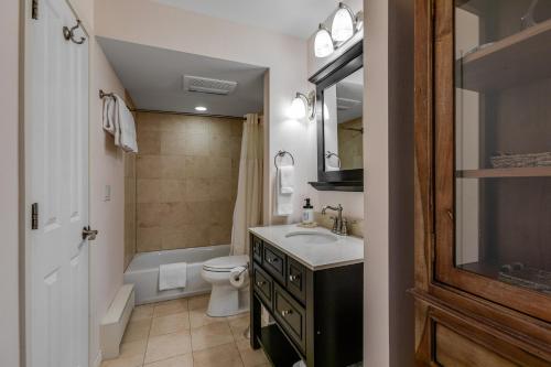 a bathroom with a sink and a toilet and a tub at Woodbridge Condo by Snowmass Vacations in Snowmass Village