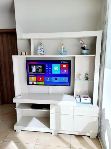 a white entertainment center with a flat screen tv at Fantastic Beach condo with pool and mountain views in Nueva Gorgona