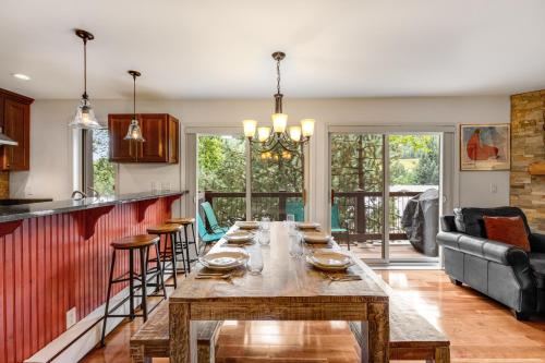 a large wooden table in a kitchen with a couch at Woodbridge Condo by Snowmass Vacations in Snowmass Village