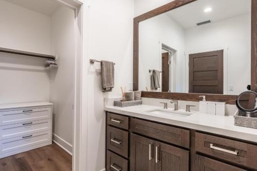 a bathroom with a sink and a large mirror at Creekhouse 1583 in Mammoth Lakes