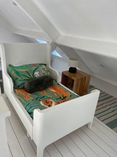 a white chair with a pillow on it in a room at Harcombe Barn near Bristol in Bristol
