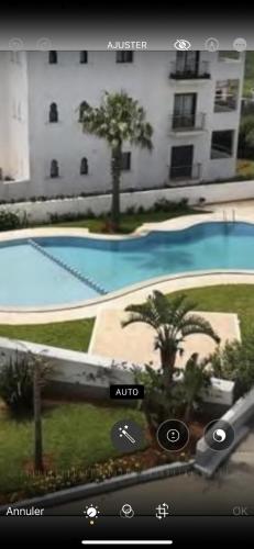 a view of a swimming pool from a hotel at Appartement haut standing jardins Assilah in Asilah