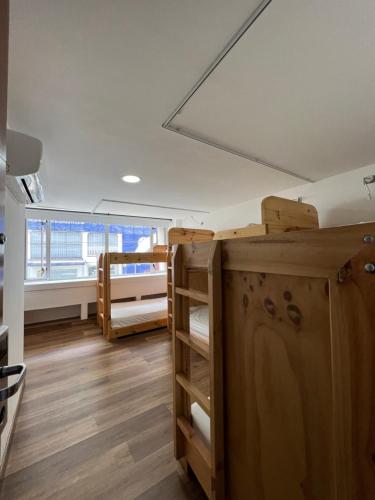 a room with bunk beds and a large window at Hotel Florencia Plaza in Medellín