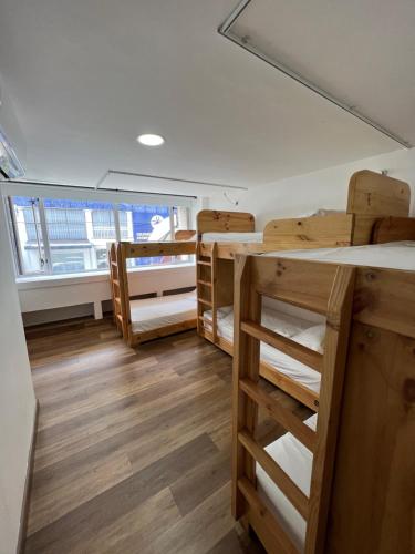 a room with bunk beds and a large window at Hotel Florencia Plaza in Medellín