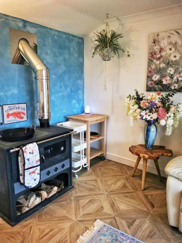 a living room with a stove in a room at The Lodge in Newton Stewart