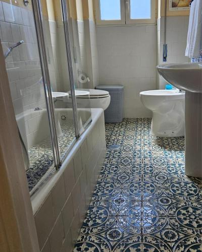 a bathroom with a shower and a toilet and a sink at Royal House Reggia in Caserta