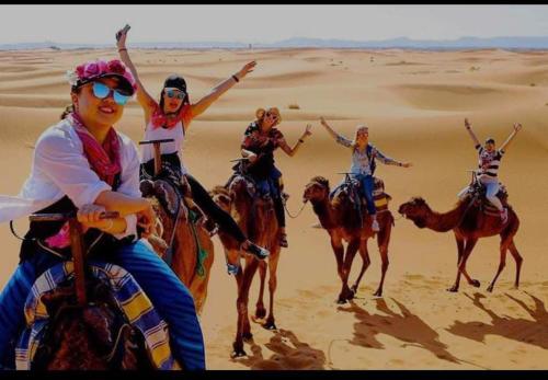 un grupo de gente montando caballos en el desierto en Cafe Restaurant Etto, en Khamliya