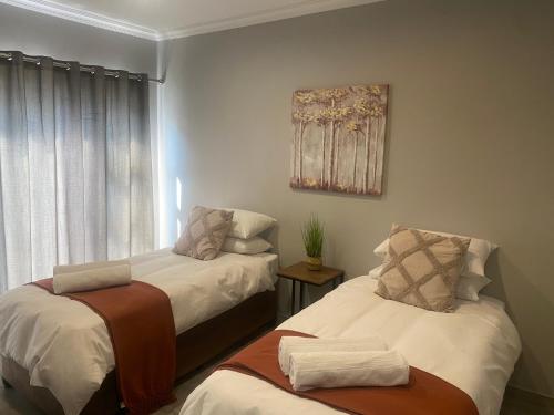 a bedroom with two beds and a window at 2968@Kingfisher in Parys