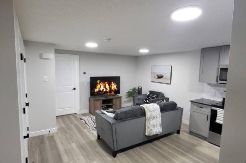 a living room with a couch and a fireplace at Serene Haven - 1 bedroom apartment. in Calgary