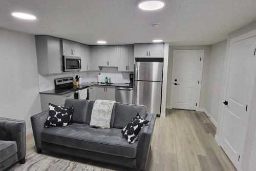 a living room with a couch and a kitchen at Serene Haven - 1 bedroom apartment. in Calgary