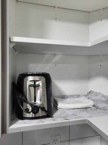 a toaster sitting on a shelf in a kitchen at Serene Haven - 1 bedroom apartment. in Calgary
