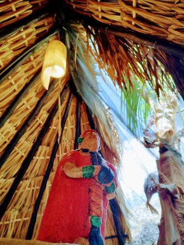 a figurine of a man in a thatch hut at Hotel y Museo Aldea Maya Toktli Orígenes - Suite Casa Maya 3 Culturas - Alberca, Wifi Starlink, Tour Museo in Izamal