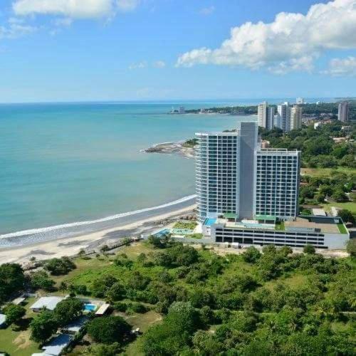 an aerial view of a beach with buildings and the ocean at Fantastic Beach condo with pool and mountain views in Nueva Gorgona