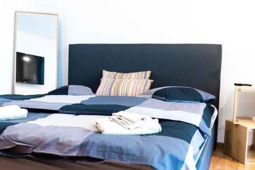 two beds in a bedroom with towels on them at Thome Bucegi Studio in Cluj-Napoca
