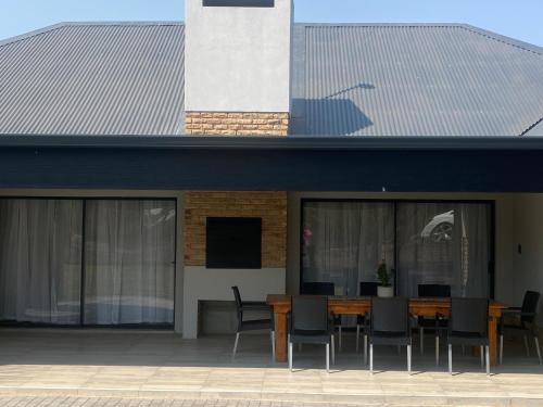 a building with a table and chairs on a patio at 2968@Kingfisher in Parys