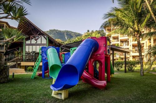 - une aire de jeux avec toboggan dans la pelouse dans l'établissement Porto Bali Resort - Apartamento em Angra dos Reis 6, à Angra dos Reis