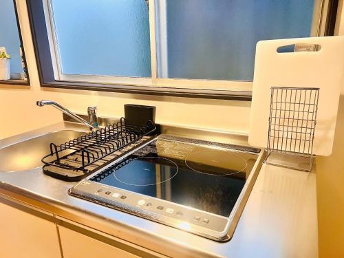 a kitchen counter with a sink and a stove at CONNECT, - Vacation STAY 16929v in Arita