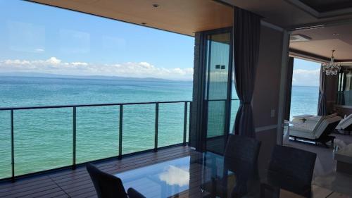a room with a balcony with a view of the ocean at Namioto Terrace Suite Villa in AIGA - Vacation STAY 30549v in Sumoto