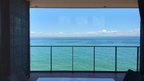 a view of the ocean from a balcony at Namioto Terrace Suite Villa in AIGA - Vacation STAY 30549v in Sumoto