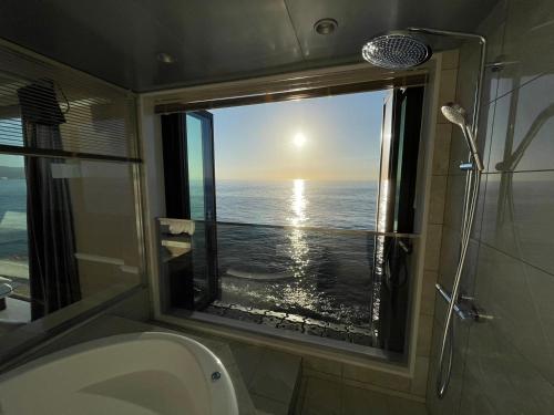 a bathroom with a window with a view of the ocean at Namioto Terrace Suite Villa in AIGA - Vacation STAY 30549v in Sumoto