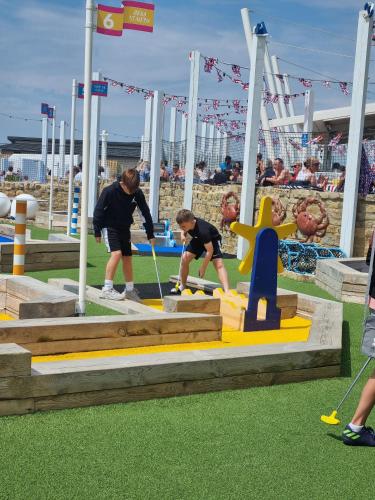 a group of people playing a game in a playground at Memories Made in Selsey