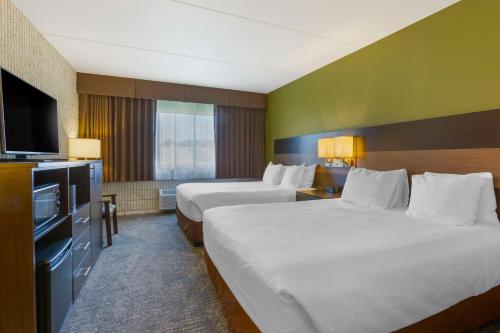 Ένα ή περισσότερα κρεβάτια σε δωμάτιο στο Best Western Plus University Inn