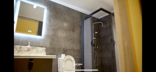 y baño con ducha, lavabo y aseo. en Hotel Atlal en Saidia 