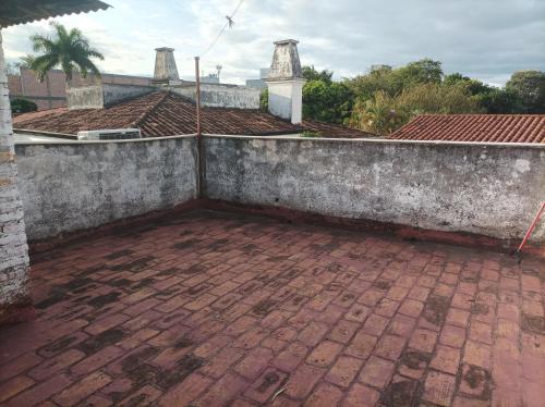 an outside view of a house with a brick patio at Villamorra house in Asunción