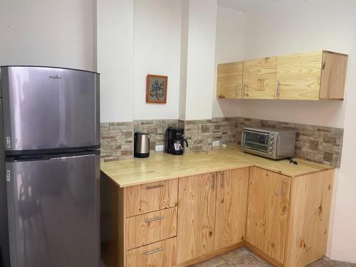 a kitchen with a stainless steel refrigerator and a microwave at Sofia Apartments in Escalante, San Jose Center in San José