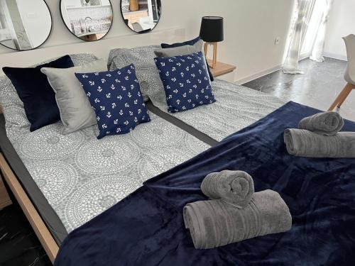 a bed with towels and pillows on top of it at Villa Laki Rab Studio App Teras in Banjol