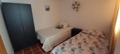 a small bedroom with a bed and a cabinet at Apartamento amoblado nuevo en Guadalajara de Buga in Buga