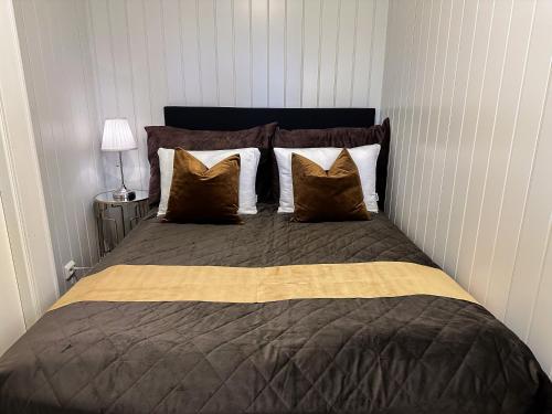 a bedroom with a large bed with brown and white pillows at Panorama View - FREE Parking - PERFECT For Couples in Tromsø