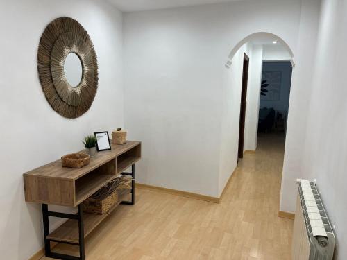 a hallway with a mirror and a table and a piano at Origen HARO ventilla in Haro