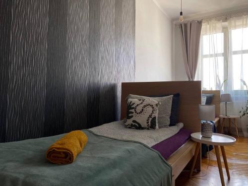 a bedroom with a bed and a table and a window at REAL VIP Hostel in Krakow