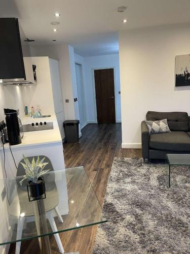 a living room with a couch and a glass table at One Bedroom Apartment/Studio in Birmingham