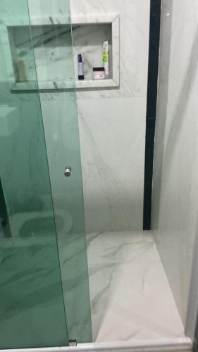 a shower with a glass door in a bathroom at Casa bela in Lauro de Freitas