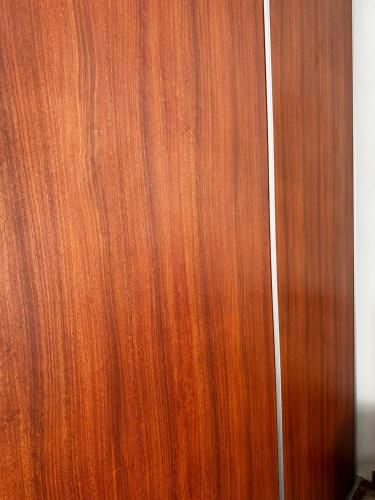 a brown wooden door of a room at Dormitorio en San Miguel in La Paz