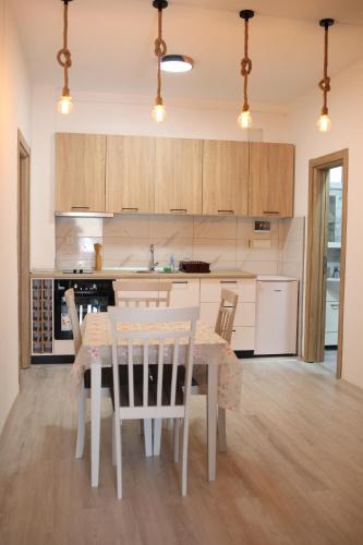 a kitchen with a table and chairs in a room at Cavleski apartment in Prilep