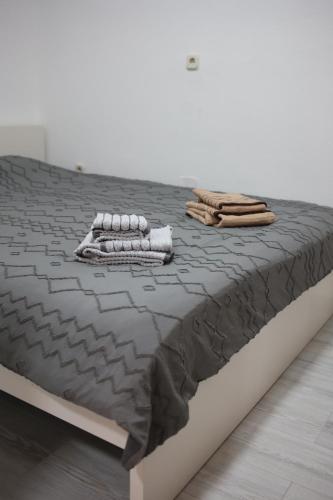 a bed with two towels on top of it at Cavleski apartment in Prilep