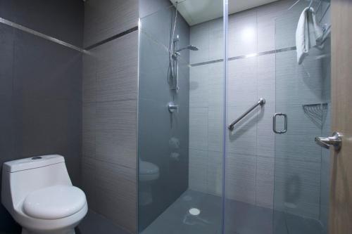 a bathroom with a toilet and a glass shower at Crowne Plaza Hotel Mexico City North-Tlalnepantla by IHG in Mexico City