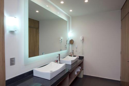 a bathroom with two sinks and a large mirror at Crowne Plaza Hotel Mexico City North-Tlalnepantla by IHG in Mexico City