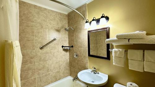 a bathroom with a sink and a toilet and a shower at Relax Inn Vinita in Vinita