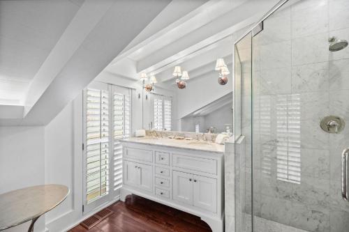 a white bathroom with a shower and a sink at Our Happy Place in Santa Rosa Beach