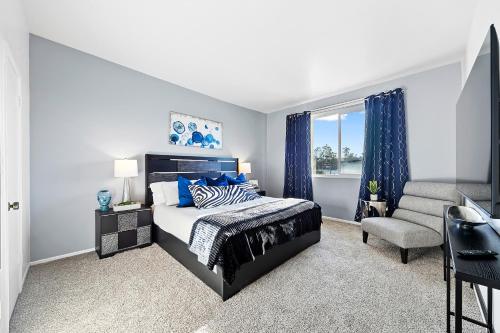 a bedroom with a king sized bed and a chair at Beverly Hills Penthouse 2 BR Apt with Parking 407 in Los Angeles