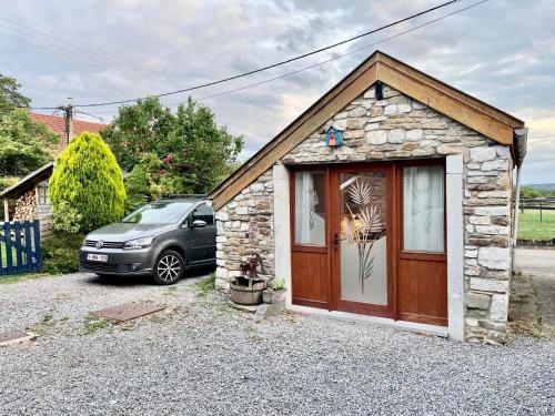 a small house with a car parked in front of it at Four à pain in Sprimont