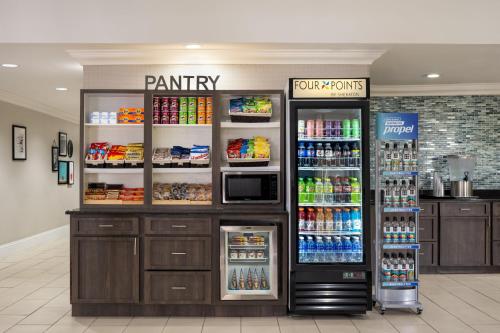 a pantry with two refrigerators in a store at Four Points by Sheraton Orlando International Drive in Orlando