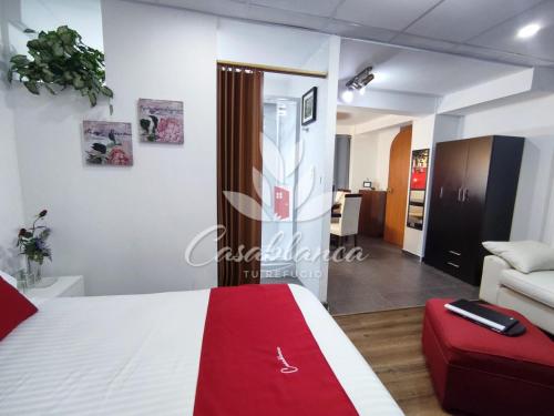 a bedroom with a bed and a living room at Casablanca 3 in Tacna