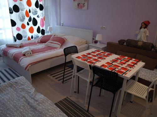 a room with a bed and a table and chairs at Apartments Kamenecki in Krapina