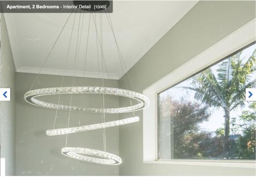 a chandelier in a room with a window at Albany Modern Private 2 bedroom 2 bathroom with Full Kitchen Netflix in Auckland